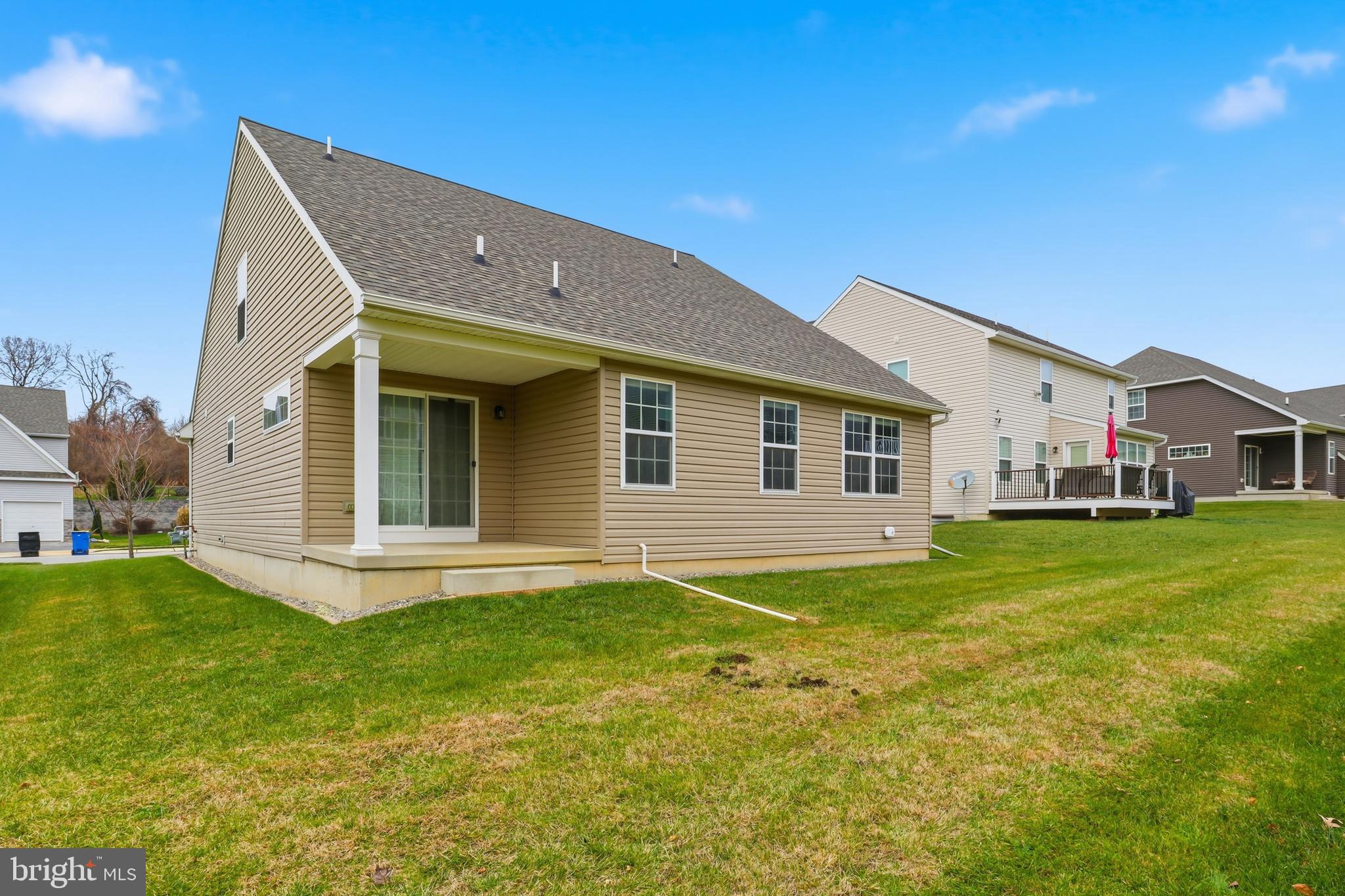 2606 Woodspring Drive York, PA 17402 - Photo 40 of 60 a front view of a house with a garden