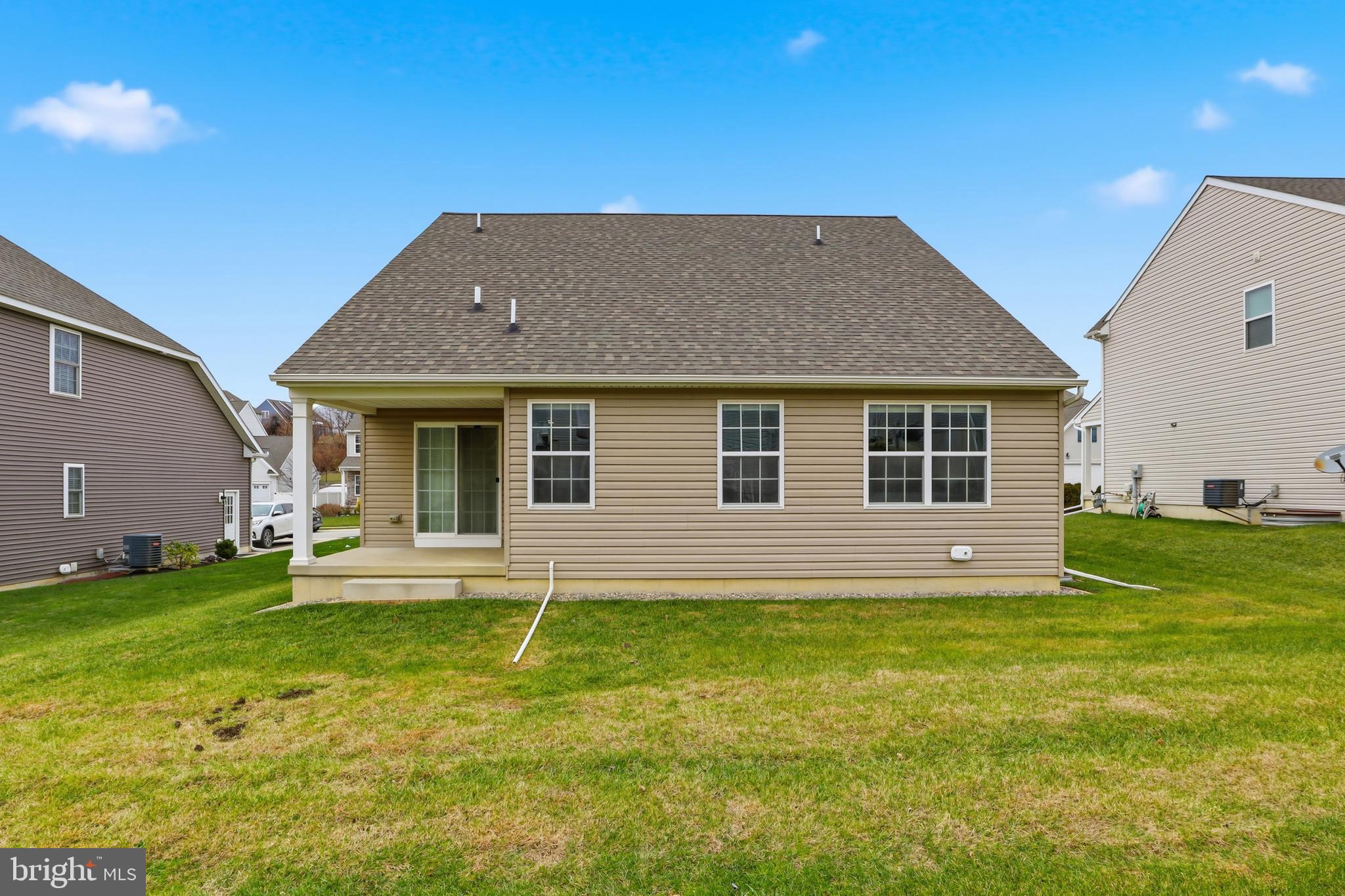 2606 Woodspring Drive York, PA 17402 - Photo 41 of 60 a front view of a house with a garden and yard