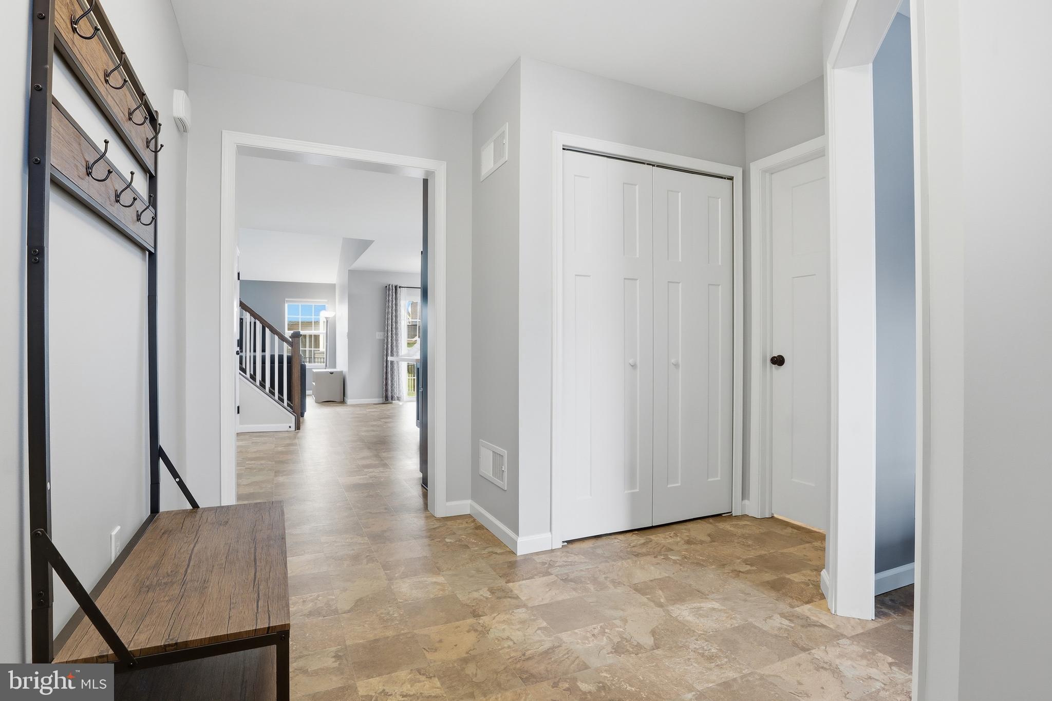 2606 Woodspring Drive York, PA 17402 - Photo 6 of 60 a view of a hallway with wooden floor and staircase