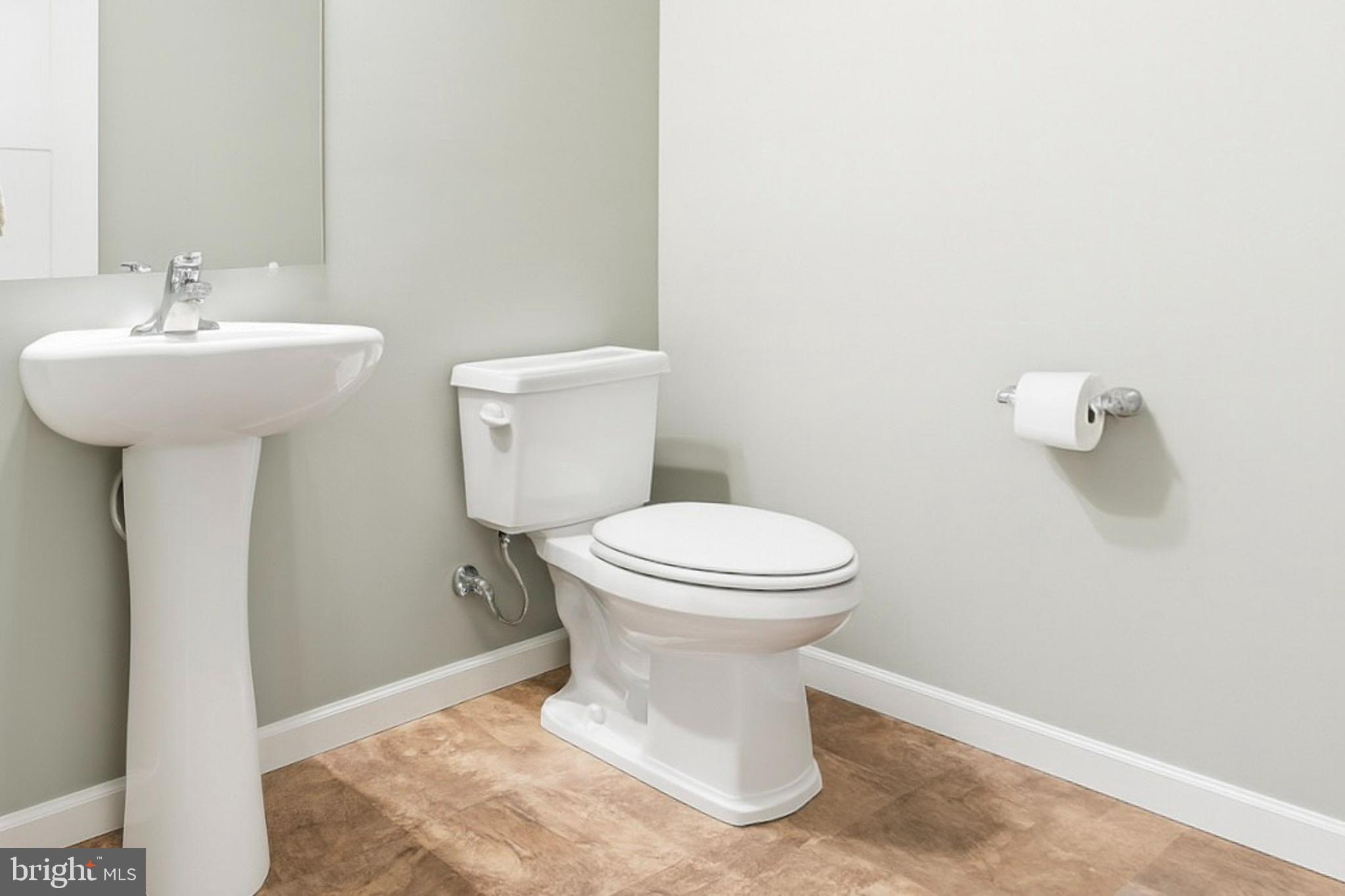 2606 Woodspring Drive York, PA 17402 - Photo 9 of 60 a white toilet sitting next to a bathroom sink