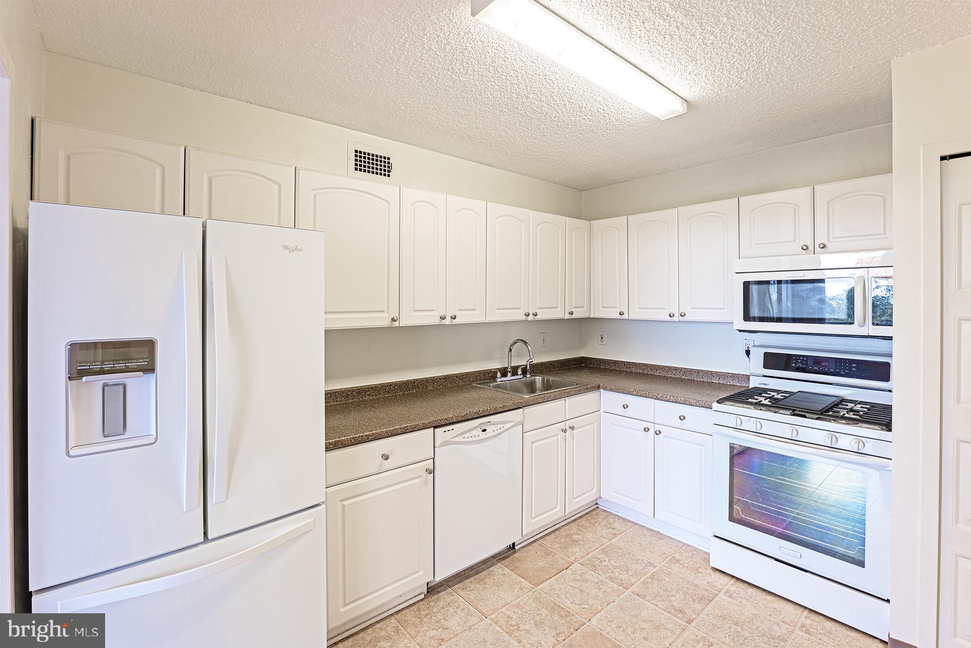 5225 Pooks Hill Road, Unit 721S Bethesda, MD 20814 - Photo 11 of 22 a kitchen with cabinets appliances and a sink