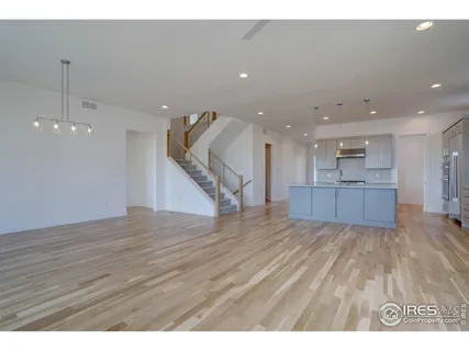 a view of kitchen and hall with wooden floor