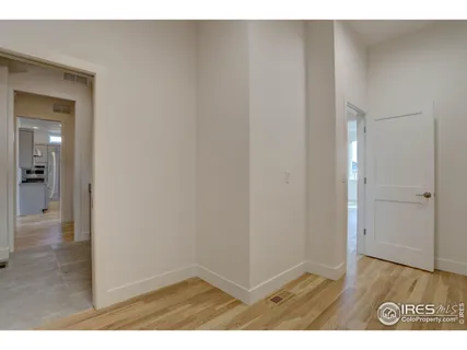 a view of an empty room and wooden floor