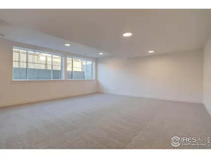 a view of an empty room with window and hallway