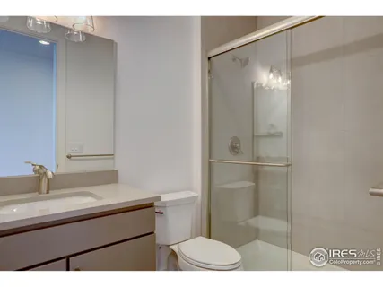 a bathroom with a sink toilet a mirror and shower