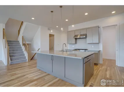 a view of kitchen with cabinets and wooden floor