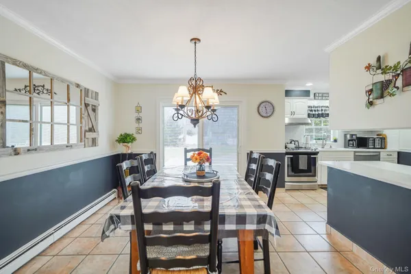 a view of a dining room with furniture and a chandelier