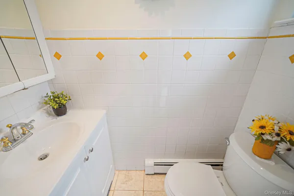 a bathroom with a sink a toilet and a shower curtain