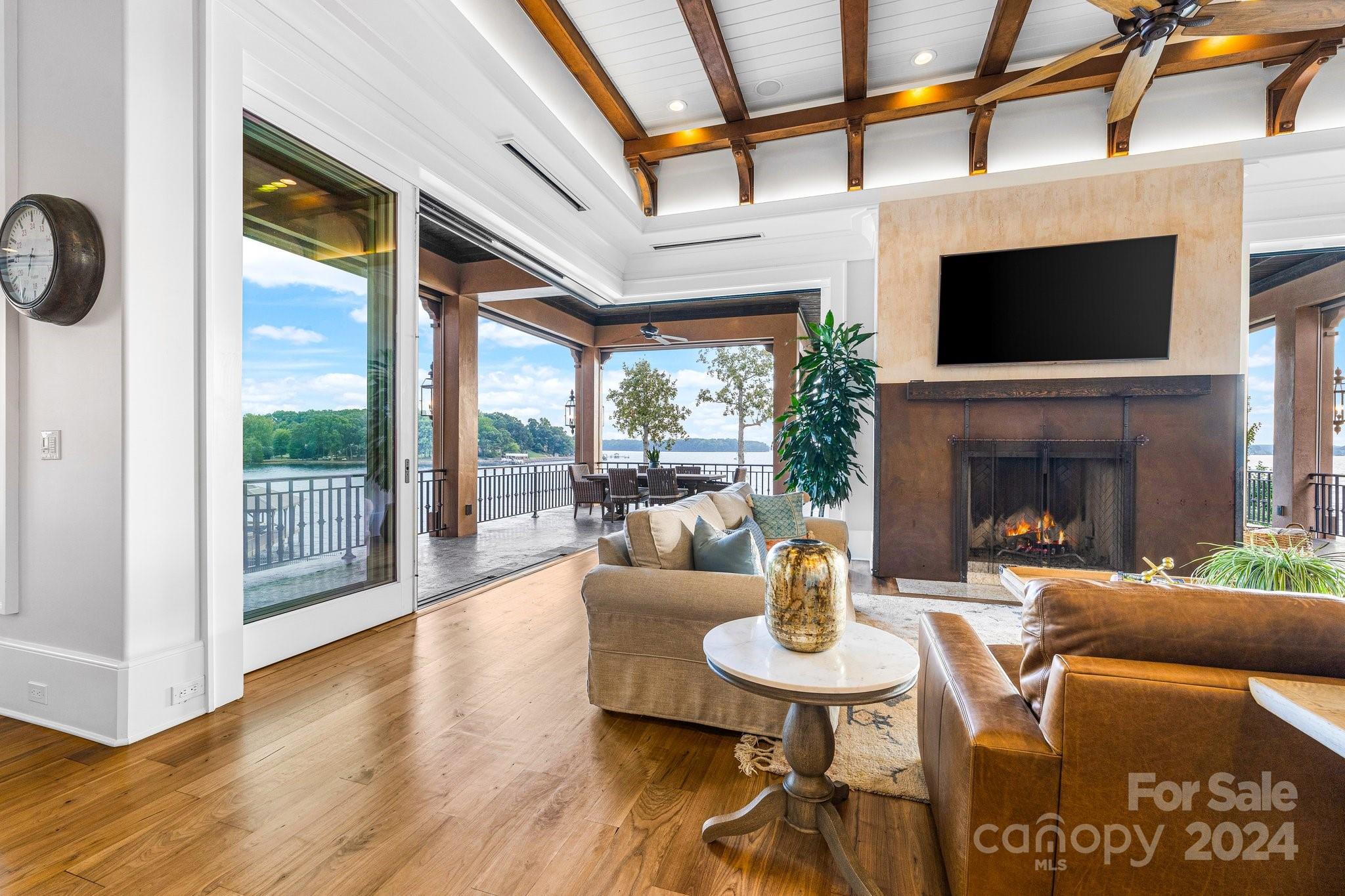 16700 Tinker Place Cornelius, NC 28031 - Photo 16 of 47 a living room with fireplace furniture and a flat screen tv