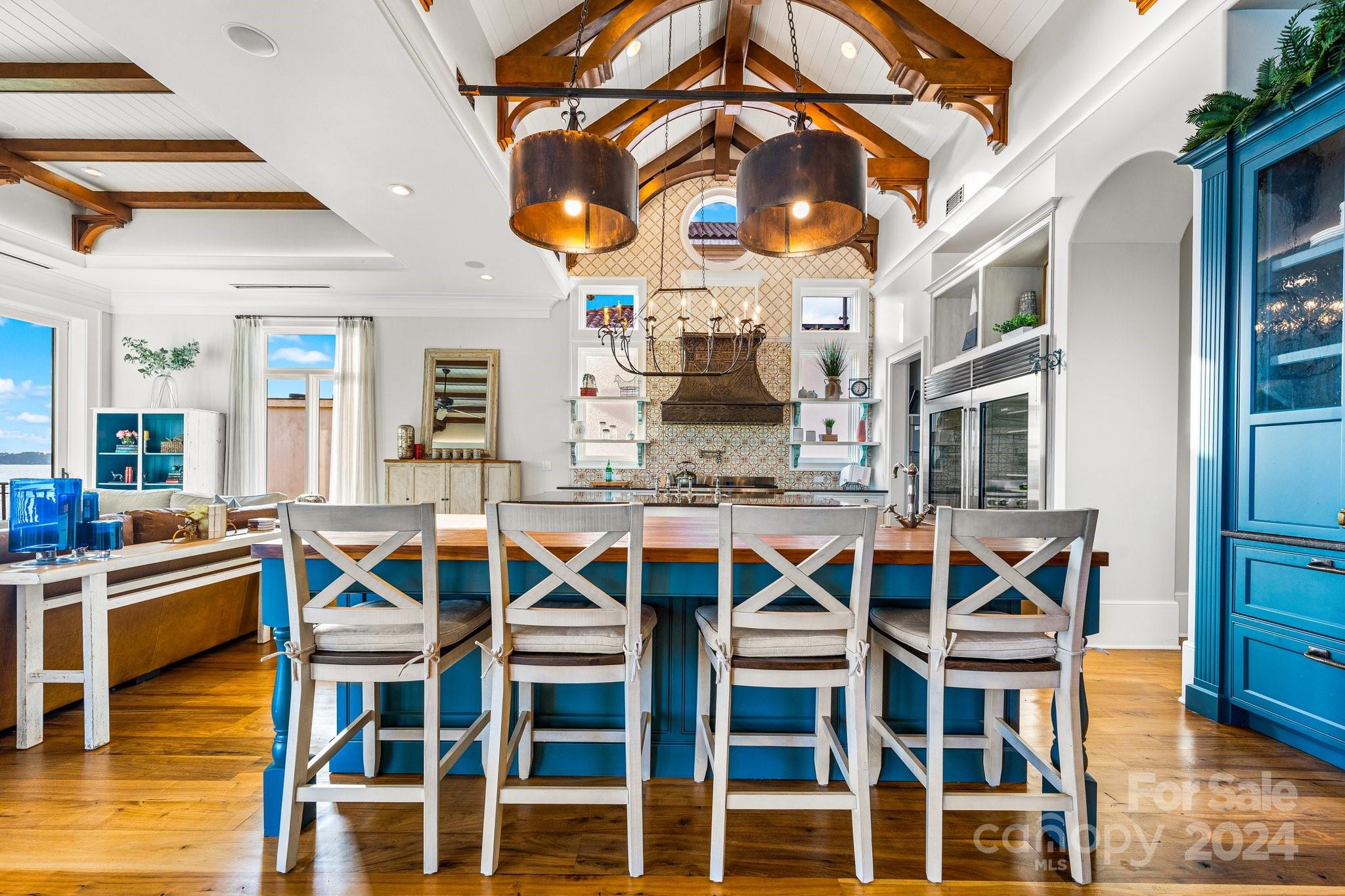 16700 Tinker Place Cornelius, NC 28031 - Photo 18 of 47 a view of a dining hall with a dining table and chairs with wooden floor