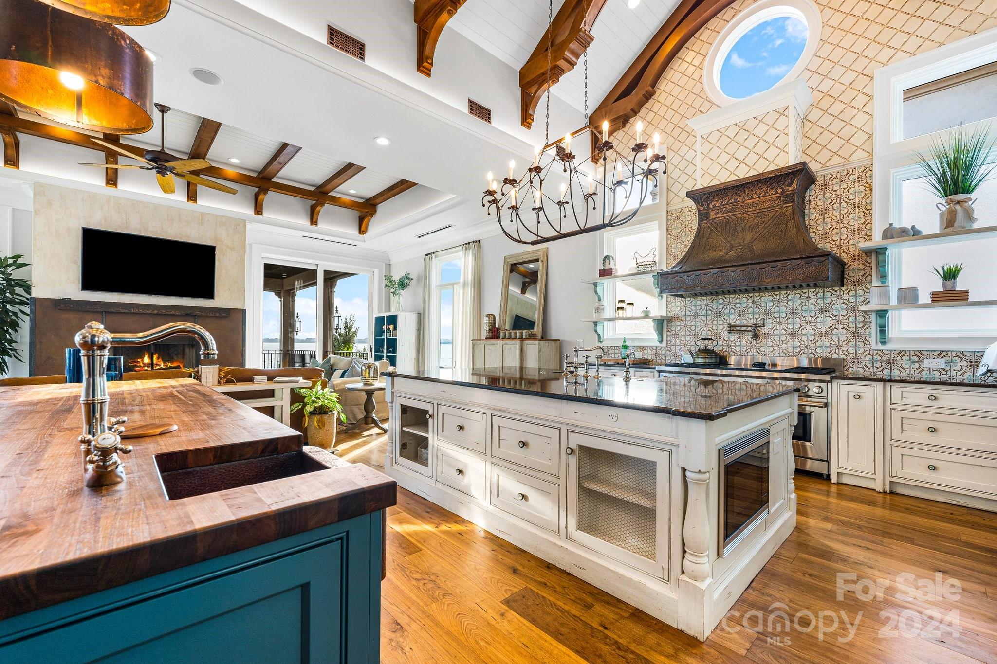 16700 Tinker Place Cornelius, NC 28031 - Photo 19 of 47 a kitchen with stainless steel appliances granite countertop a sink a stove and a microwave
