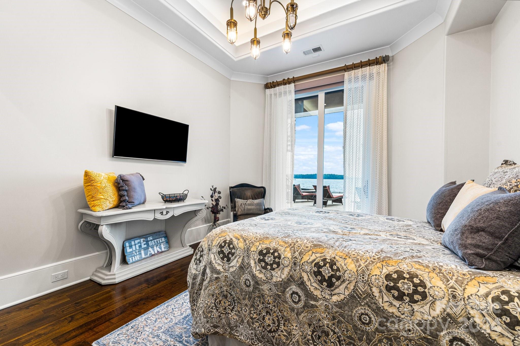 16700 Tinker Place Cornelius, NC 28031 - Photo 28 of 47 a bedroom with a bed and a flat screen tv