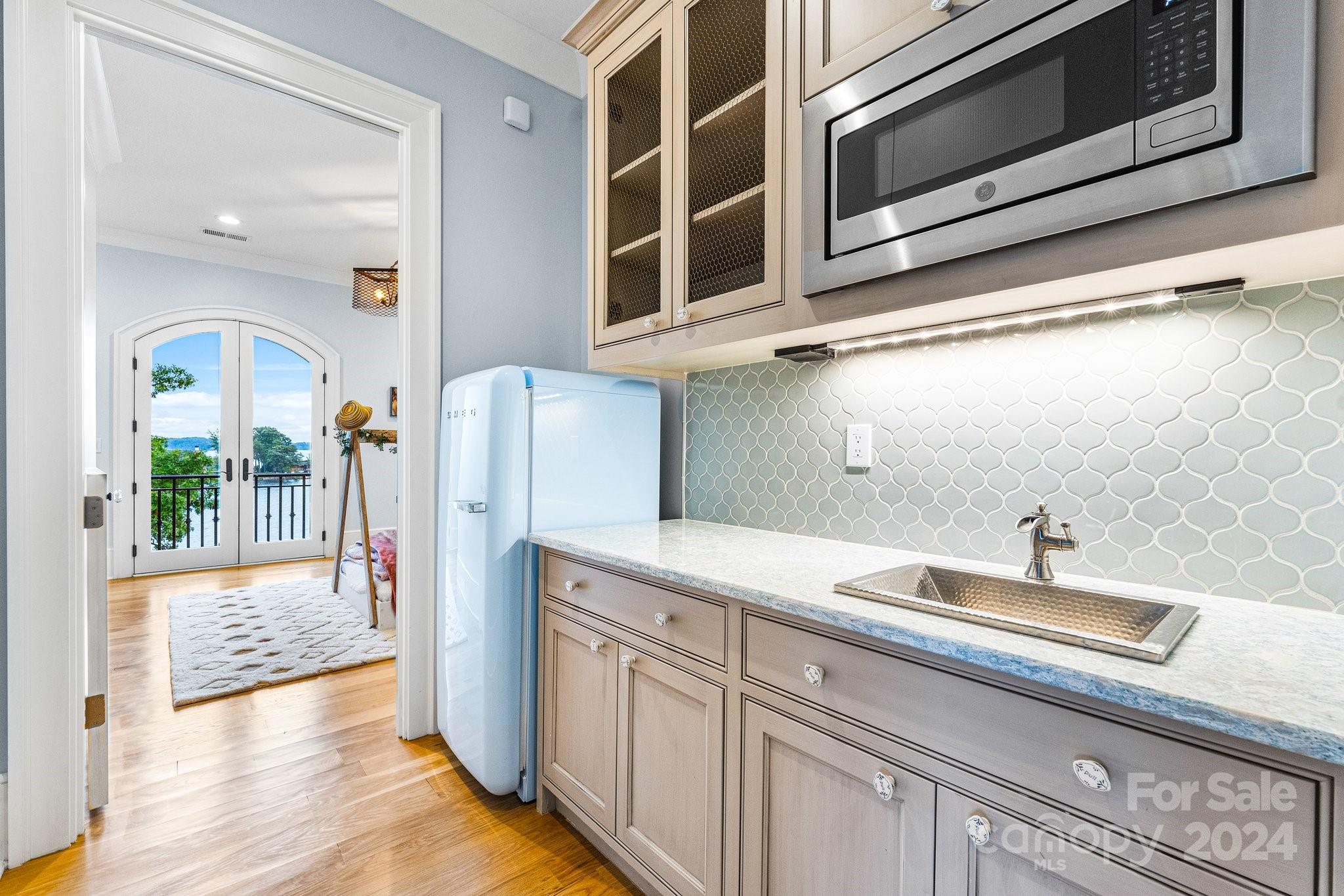16700 Tinker Place Cornelius, NC 28031 - Photo 30 of 47 a kitchen with a sink and a refrigerator