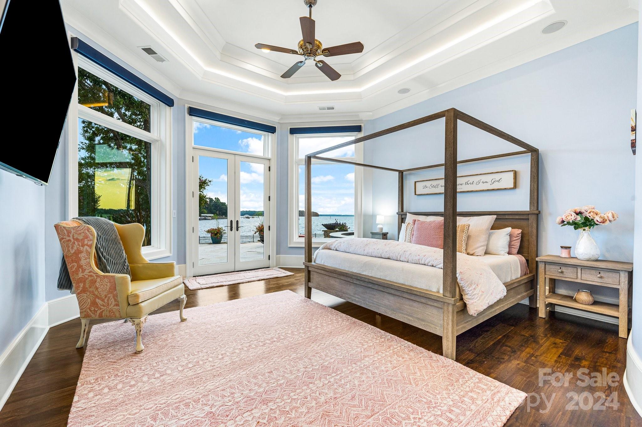 16700 Tinker Place Cornelius, NC 28031 - Photo 32 of 47 a bedroom with a bed a flat screen tv and a large window