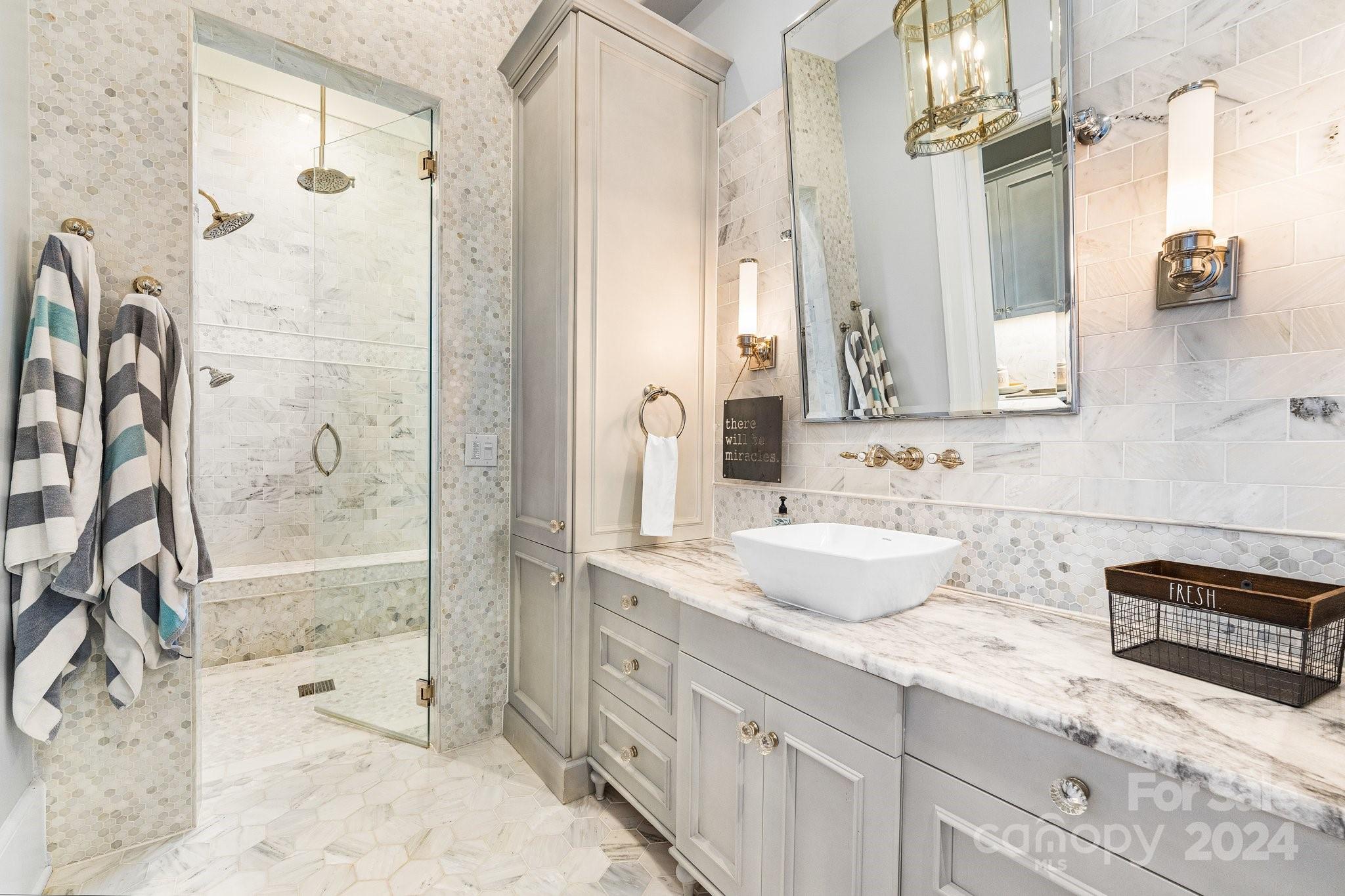 16700 Tinker Place Cornelius, NC 28031 - Photo 33 of 47 a bathroom with a granite countertop sink a mirror a shower and a bathtub