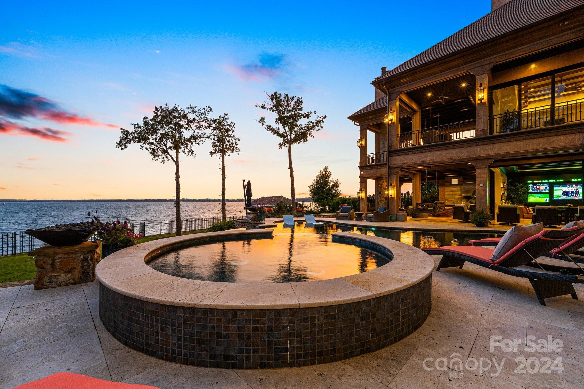 16700 Tinker Place Cornelius, NC 28031 - Photo 6 of 47 a view of a swimming pool with a patio and a fire pit
