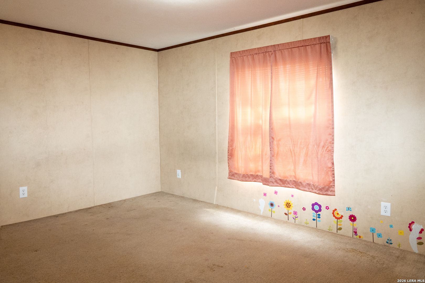 507 Beech Street Jourdanton, TX 78026 - Photo 11 of 17 an empty room with a window and toys