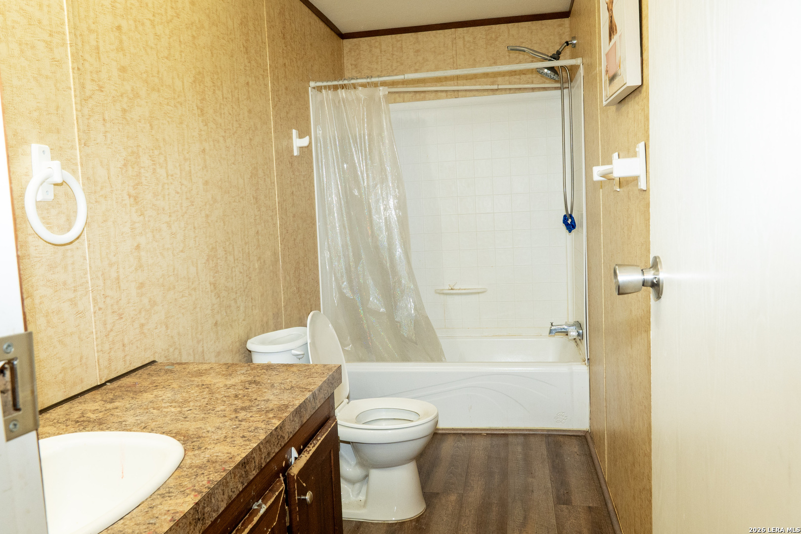 507 Beech Street Jourdanton, TX 78026 - Photo 13 of 17 a bathroom with a granite countertop sink toilet and shower