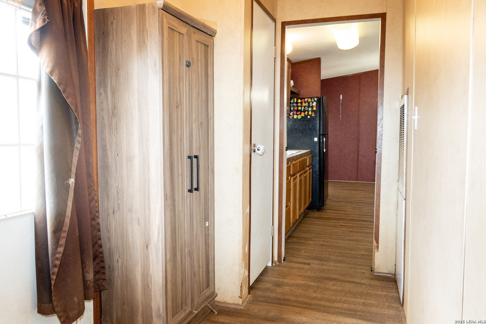 507 Beech Street Jourdanton, TX 78026 - Photo 15 of 17 a view of a hallway with wooden floor