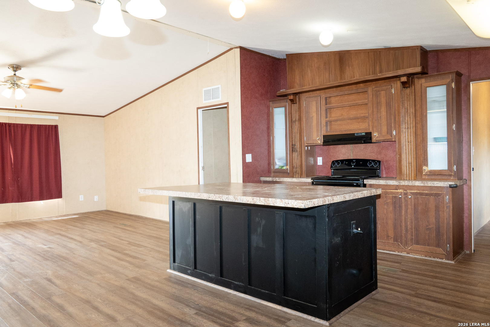 507 Beech Street Jourdanton, TX 78026 - Photo 5 of 17 a kitchen with stainless steel appliances granite countertop a sink and a refrigerator