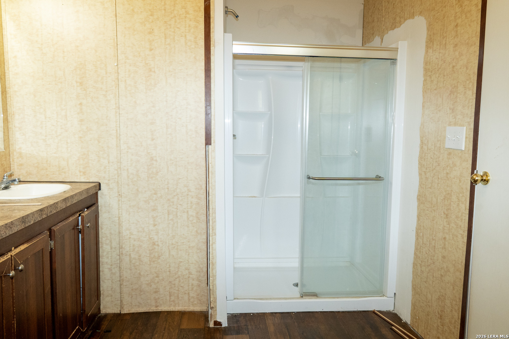 507 Beech Street Jourdanton, TX 78026 - Photo 9 of 17 a bathroom with a granite countertop sink and a mirror
