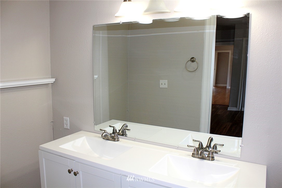 18445 Forstrom Street Southwest Rochester, WA 98579 - Photo 11 of 14 a bathroom with a sink vanity and a mirror