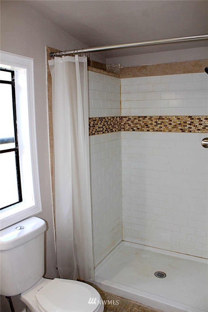 18445 Forstrom Street Southwest Rochester, WA 98579 - Photo 12 of 14 a bathroom with a shower and a toilet