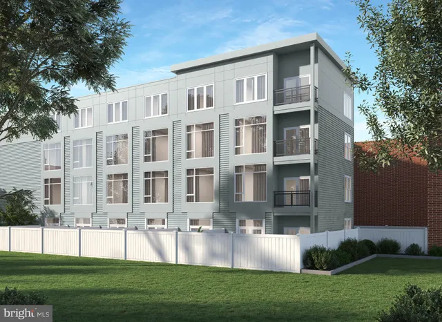 a front view of a residential apartment building with a yard