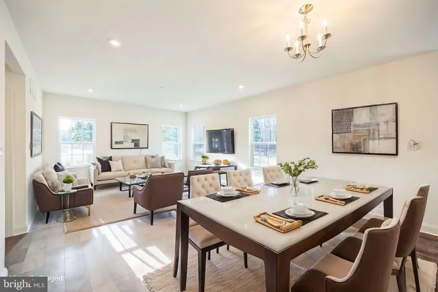 a kitchen with a table chairs stove and cabinets