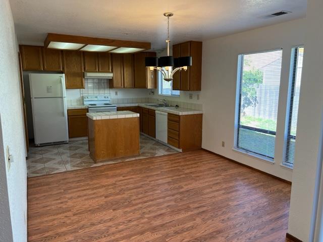239 Mortimer Lane Marina, CA 93933 - Photo 35 of 87 a kitchen with stainless steel appliances granite countertop a sink a stove a refrigerator and cabinets
