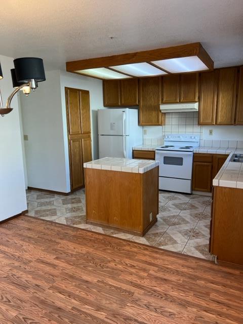 239 Mortimer Lane Marina, CA 93933 - Photo 36 of 87 a kitchen with stainless steel appliances wooden cabinets a stove a sink and a refrigerator