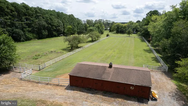 an aerial view of a house with a yard and trees
