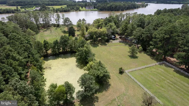 a front view of a house with a garden and trees