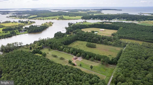 an aerial view of residential houses with outdoor space and river