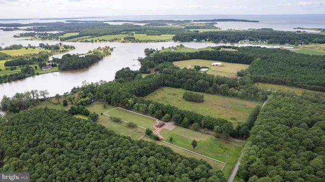 an aerial view of residential houses with outdoor space and river