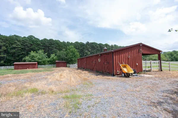 a view of a field with trees in the background