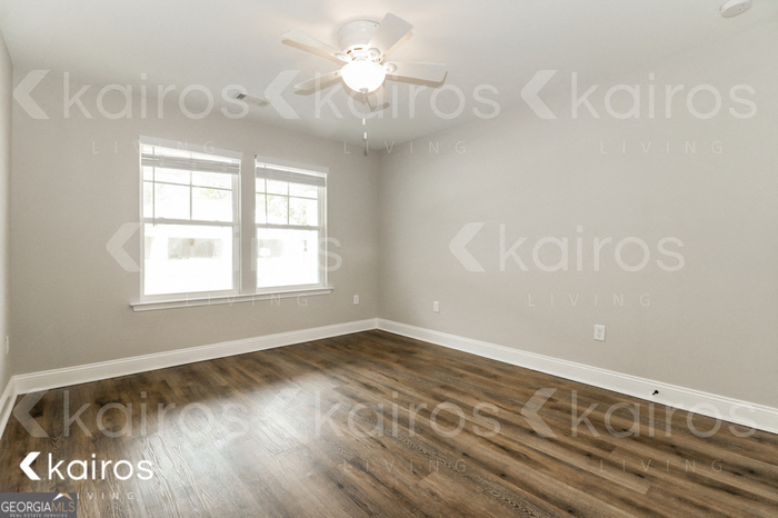 153 Cottage Grove Road Brunswick, GA 31525 - Photo 11 of 16 a view of an empty room with window and wooden floor