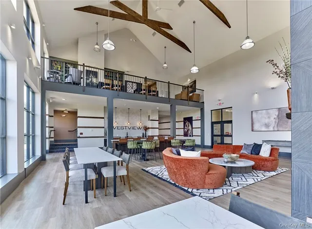 a dining room with stainless steel appliances kitchen island a table and chairs