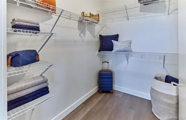 a large bed sitting in a bedroom next to a window