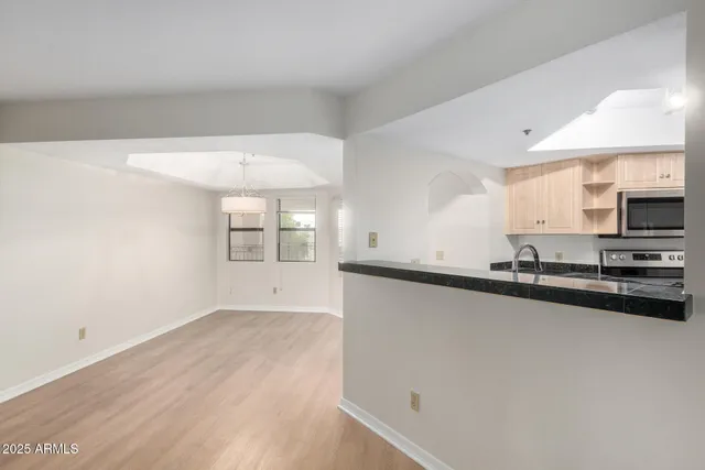 a view of a kitchen with a sink and a window