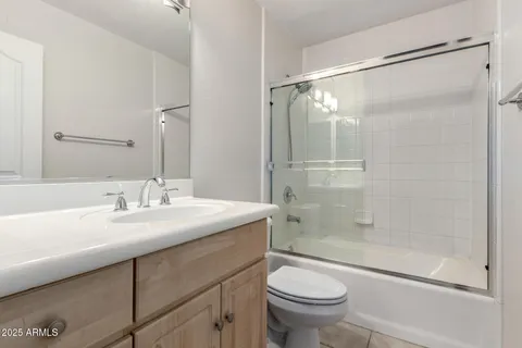 a bathroom with a sink mirror vanity and toilet