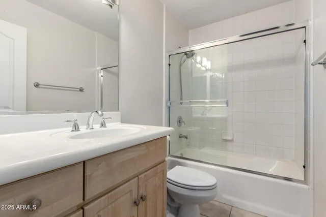 a bathroom with a sink mirror vanity and toilet