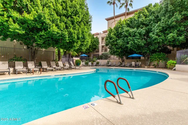 a swimming pool with outdoor seating and yard