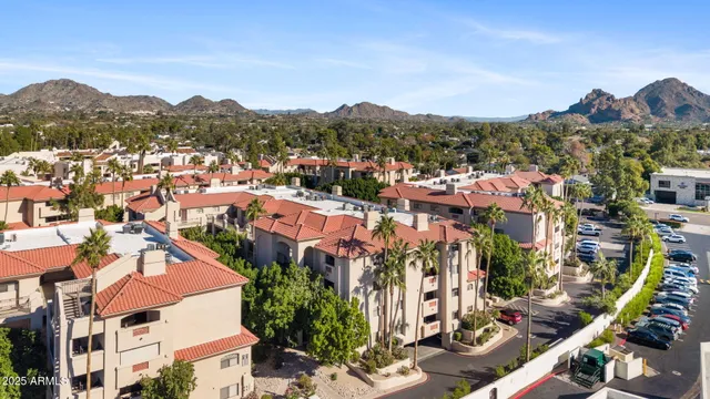 an aerial view of residential houses with outdoor space and trees