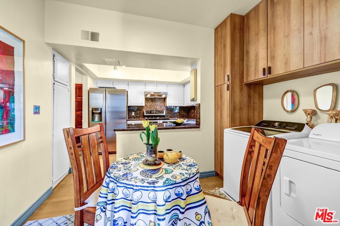1313 Valley View Road, Unit 213 Glendale, CA 91202 - Photo 16 of 31 a dining room with furniture a mirror and wooden floor