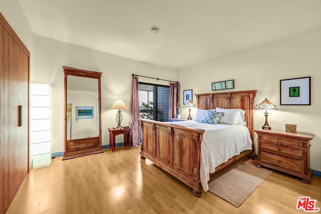 1313 Valley View Road, Unit 213 Glendale, CA 91202 - Photo 17 of 31 a spacious bedroom with a bed and wooden floor