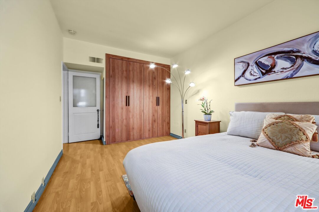 1313 Valley View Road, Unit 213 Glendale, CA 91202 - Photo 23 of 31 a bedroom with a bed and painting on the wall
