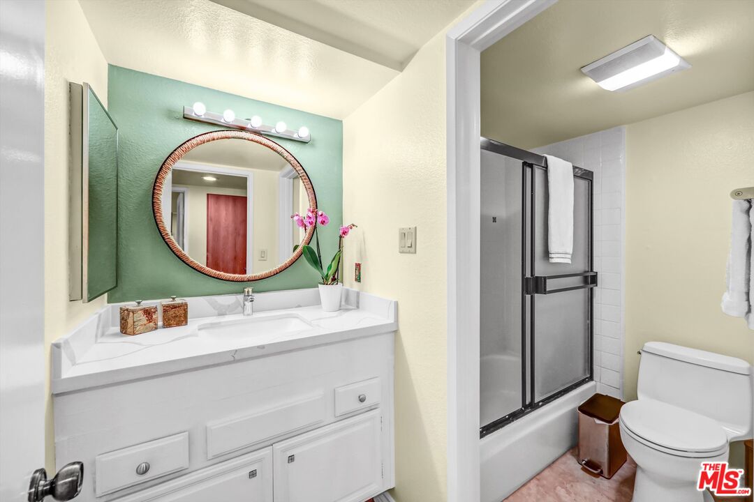 1313 Valley View Road, Unit 213 Glendale, CA 91202 - Photo 24 of 31 a bathroom with a toilet a sink and a mirror