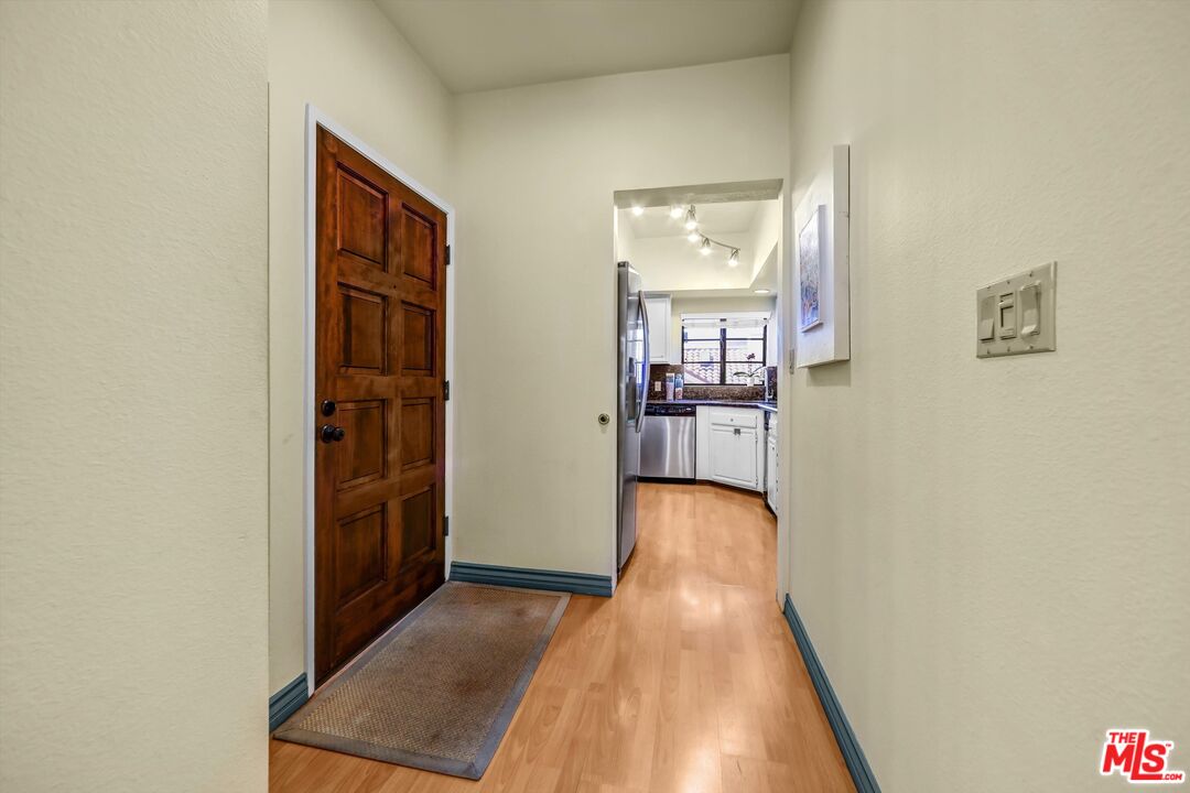1313 Valley View Road, Unit 213 Glendale, CA 91202 - Photo 4 of 31 a view of a hallway with wooden floor and a living room