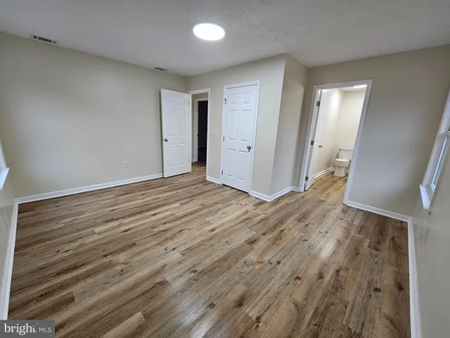 a view of hallway with wooden floor